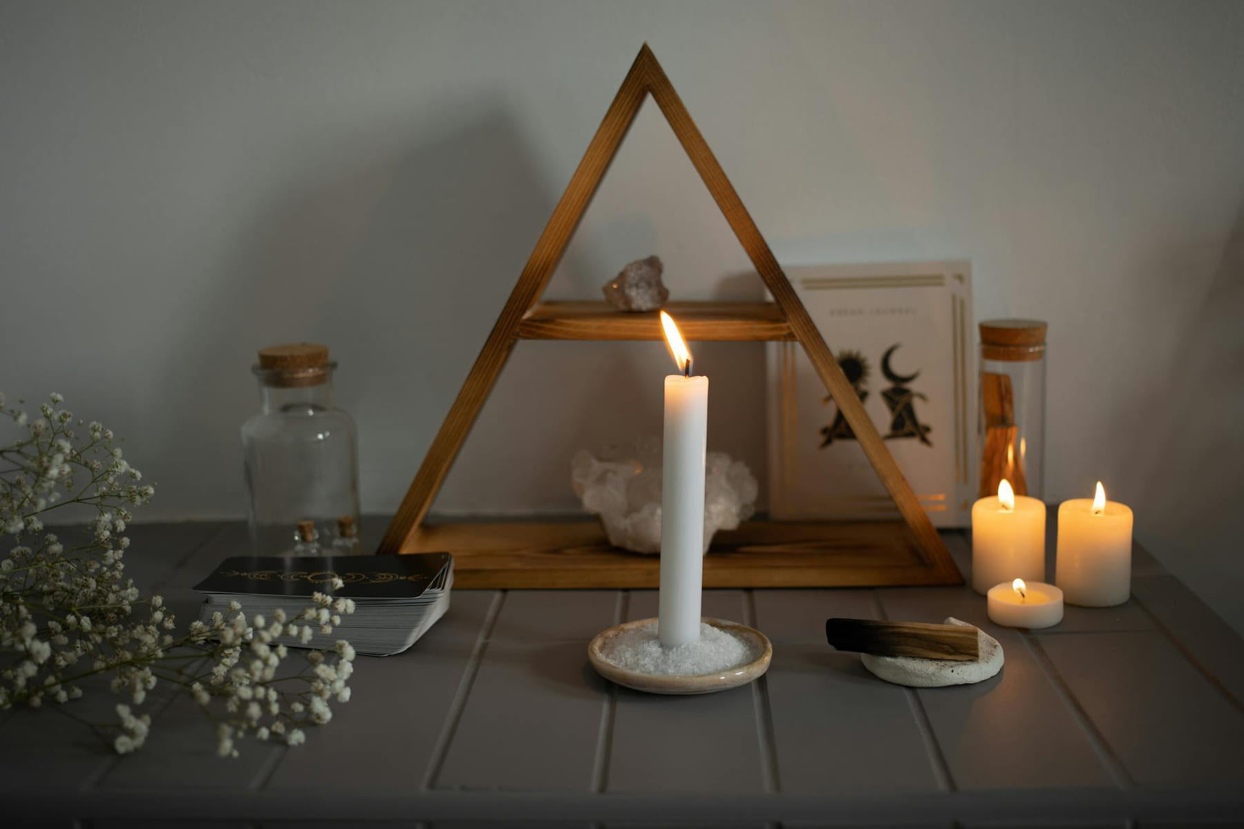 A serene spiritual setup featuring candles, crystals, and tarot cards arranged for meditation. on The Manifesting Light