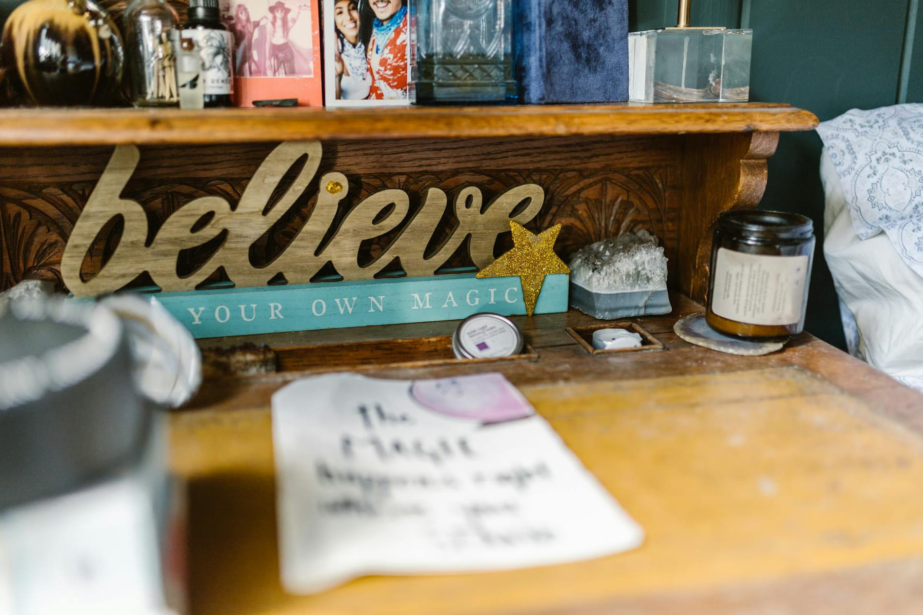 Close-up of an inspiring workspace with decorative items and a motivational sign. on The Manifesting Light