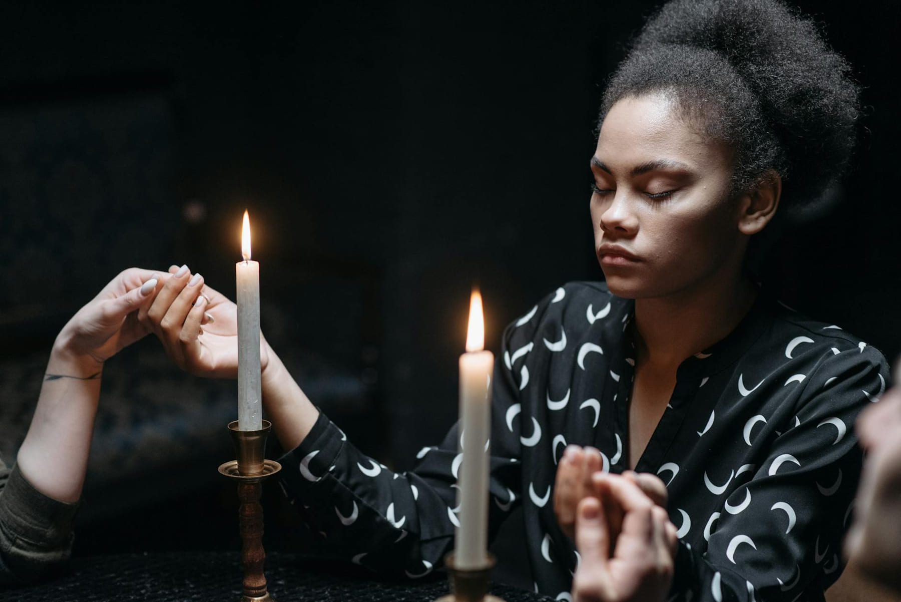 Woman with closed eyes in candlelit meditation, embodying spiritual serenity. on The Manifesting Light