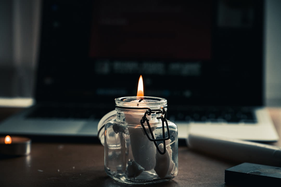 a glass jar with a candle inside of it on The Manifesting Light